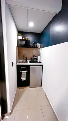 a small kitchen with a sink and a stove at Quaranta Lofts in Antiguo Cuscatlán