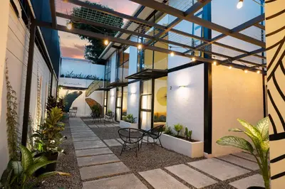 a courtyard with chairs and plants in a building at Quaranta Lofts in Antiguo Cuscatlán