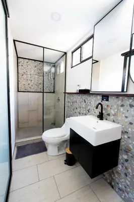 a bathroom with a white sink and a toilet at Quaranta Lofts in Antiguo Cuscatlán