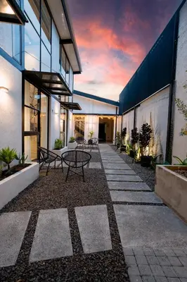 a courtyard of a building with a table and benches at Quaranta Lofts in Antiguo Cuscatlán
