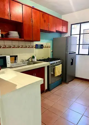 a kitchen with a refrigerator and a stove top oven at casa en la Cima in San Salvador