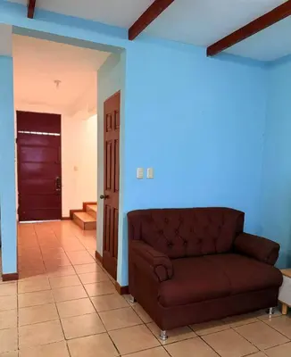 a living room with a couch in the middle of a room at casa en la Cima in San Salvador