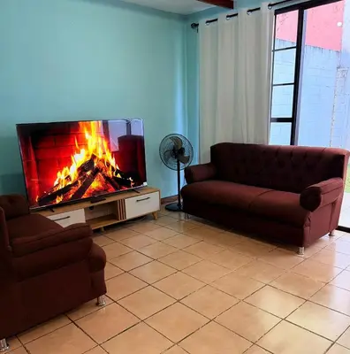 a living room with a couch and a fireplace at casa en la Cima in San Salvador
