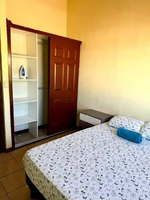 a bedroom with a bed and a red door at casa en la Cima in San Salvador