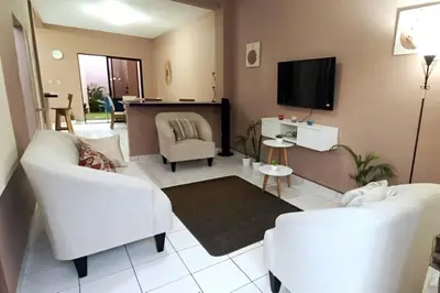 a living room with white furniture and a flat screen tv at Marron House's Arizona 2 in Santa Ana