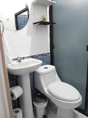 a bathroom with a white toilet and a sink at Marron House's Arizona 2 in Santa Ana