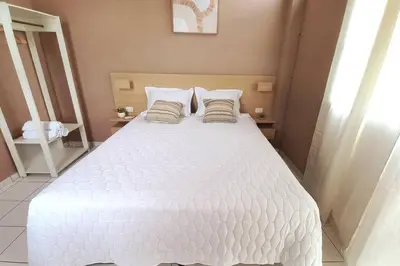 a bedroom with a white bed with two pillows at Marron House's Arizona 2 in Santa Ana