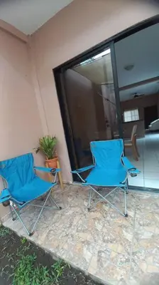 two blue chairs sitting outside of a house at Marron House's Arizona 2 in Santa Ana