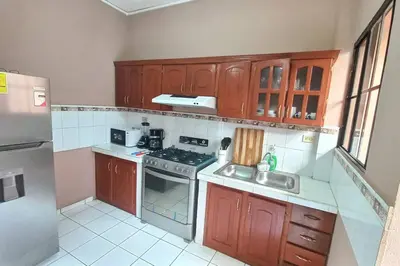a kitchen with wooden cabinets and a stove top oven at Marron House's Arizona 2 in Santa Ana