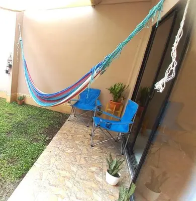 two chairs and a hammock outside of a house at Marron House's Arizona 2 in Santa Ana