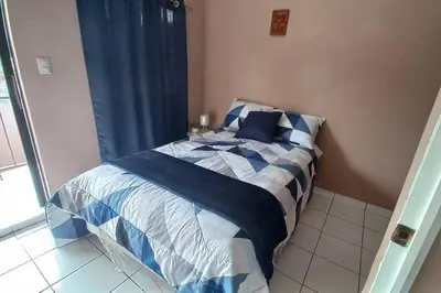 a bed with blue and white sheets in a bedroom at Marron House's Arizona 2 in Santa Ana