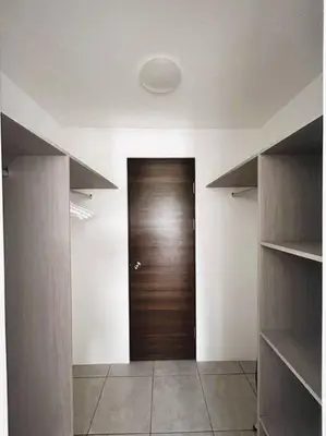 a hallway with a wooden door in a room at Amazing City Views, with Queen Bed and Pool in San Salvador