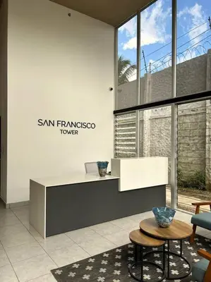 an office with a desk and a table and a chair at Amazing City Views, with Queen Bed and Pool in San Salvador