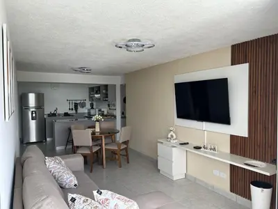 a living room with a couch and a flat screen tv at Amazing City Views, with Queen Bed and Pool in San Salvador