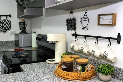 a kitchen with a counter top with a coffee maker at Amazing City Views, with Queen Bed and Pool in San Salvador