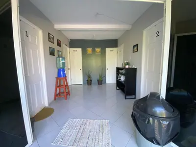 a hallway with a room with doors and a stool at Habitación cerca del aeropuerto #3 in La Paz