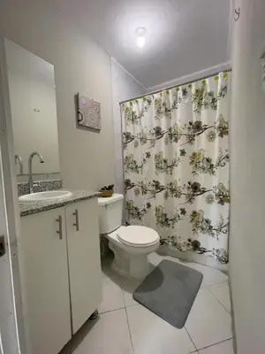 a bathroom with a toilet and a shower curtain at Habitación cerca del aeropuerto #3 in La Paz