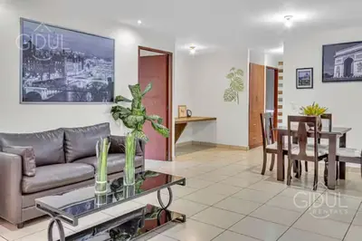 a living room with a couch and a table at San Salvador Mountain & City Views Apartment in San Salvador
