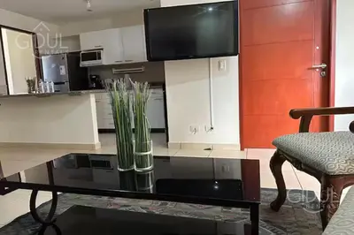 a kitchen with a table with a vase on it at San Salvador Mountain & City Views Apartment in San Salvador
