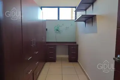 an empty room with a desk and a window at San Salvador Mountain & City Views Apartment in San Salvador