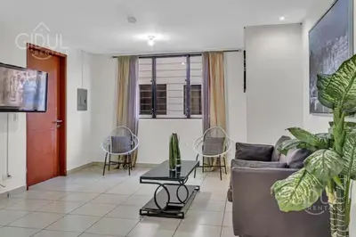 a living room with a couch and a table at San Salvador Mountain & City Views Apartment in San Salvador