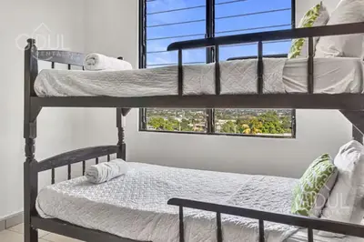 a bedroom with two bunk beds and a window at San Salvador Mountain & City Views Apartment in San Salvador