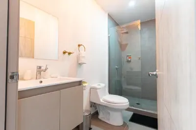 a bathroom with a toilet and a sink and a shower at Luxury apartment at Galerias in San Salvador