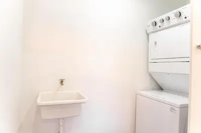 a white kitchen with a sink and a stove at Luxury apartment at Galerias in San Salvador