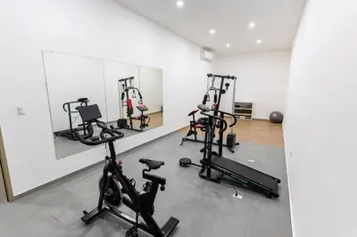a gym with several exercise bikes in a room at Luxury apartment at Galerias in San Salvador