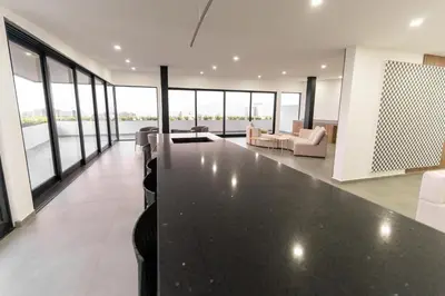 an open living room with a large black table at Luxury apartment at Galerias in San Salvador