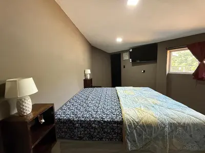 a bedroom with a bed and a window at Mini Room El Mangal B&B in Suchitoto