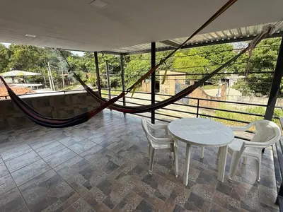 a room with a hammock and a table and chairs at Mini Room El Mangal B&B in Suchitoto