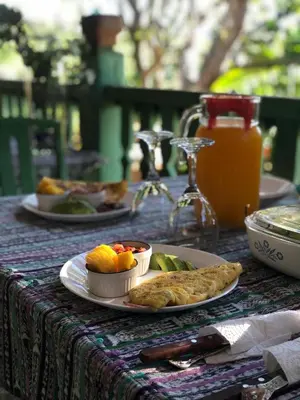 a table with plates of food on a table at Los Cuatro Olivos Hotel Boutique in Juayúa