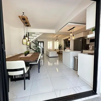 a kitchen and dining room with a table and chairs at Beauty delux home in San Miguel
