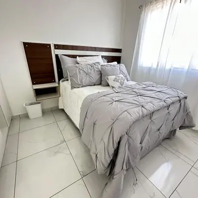 a bedroom with a bed and a window at Beauty delux home in San Miguel