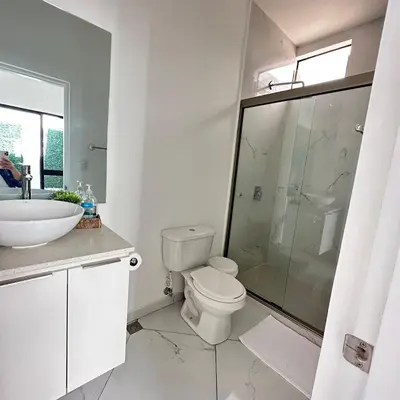a bathroom with a toilet and a sink and a shower at Beauty delux home in San Miguel