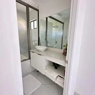 a bathroom with a sink and a large mirror at Beauty delux home in San Miguel