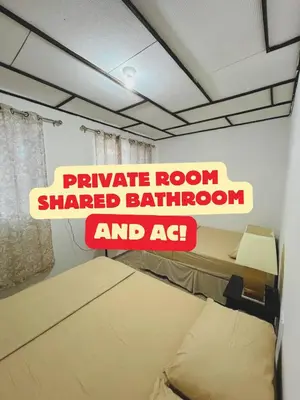 a sign that reads private room shared bathroom and ac at Urban Nest Hostel in Santa Ana