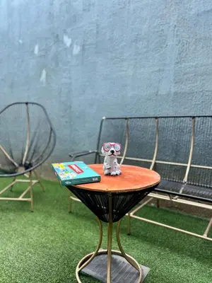 a table with a stuffed animal sitting on top of a book at Conchita's, near Mall metrocentro, AC, SHW in Santa Ana