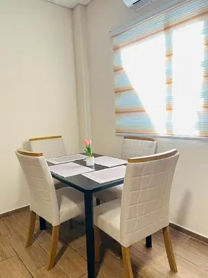 a dining room table with chairs and a window at Conchita's, near Mall metrocentro, AC, SHW in Santa Ana