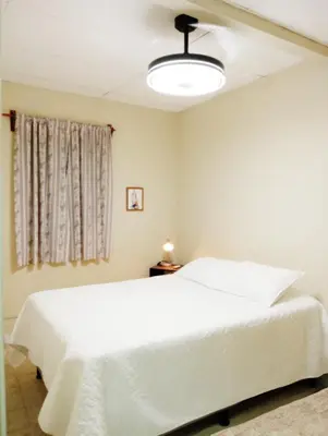 a bedroom with a white bed and a window at Double Bed in San Salvador