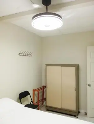 an empty room with a bed and a lamp at Double Bed in San Salvador