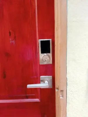 a red door with a safe on the side of it at Double Bed in San Salvador