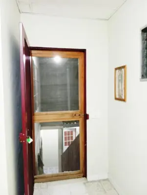 a door with a window in a room at Double Bed in San Salvador