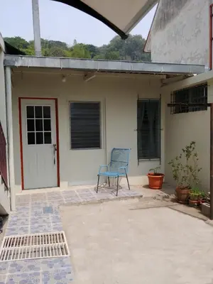 a blue chair sitting in front of a house at Double Bed in San Salvador