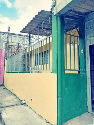 a building with a green and yellow at Double Bed in San Salvador