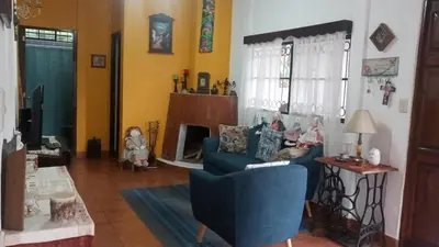 a living room with a blue couch and a chair at Cabaña Mi Bello Jardín, Privado, Zona Urbana in Apaneca