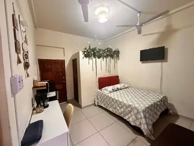 a bedroom with a bed and a desk with a computer at Zacatecoluca House in Zacatecoluca