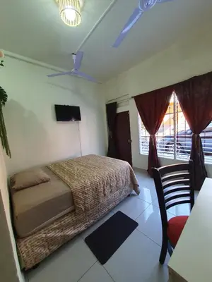a bedroom with a bed and a table and a tv at Zacatecoluca House in Zacatecoluca