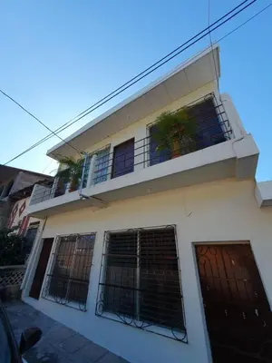 a white house with a balcony with bars at Zacatecoluca House in Zacatecoluca
